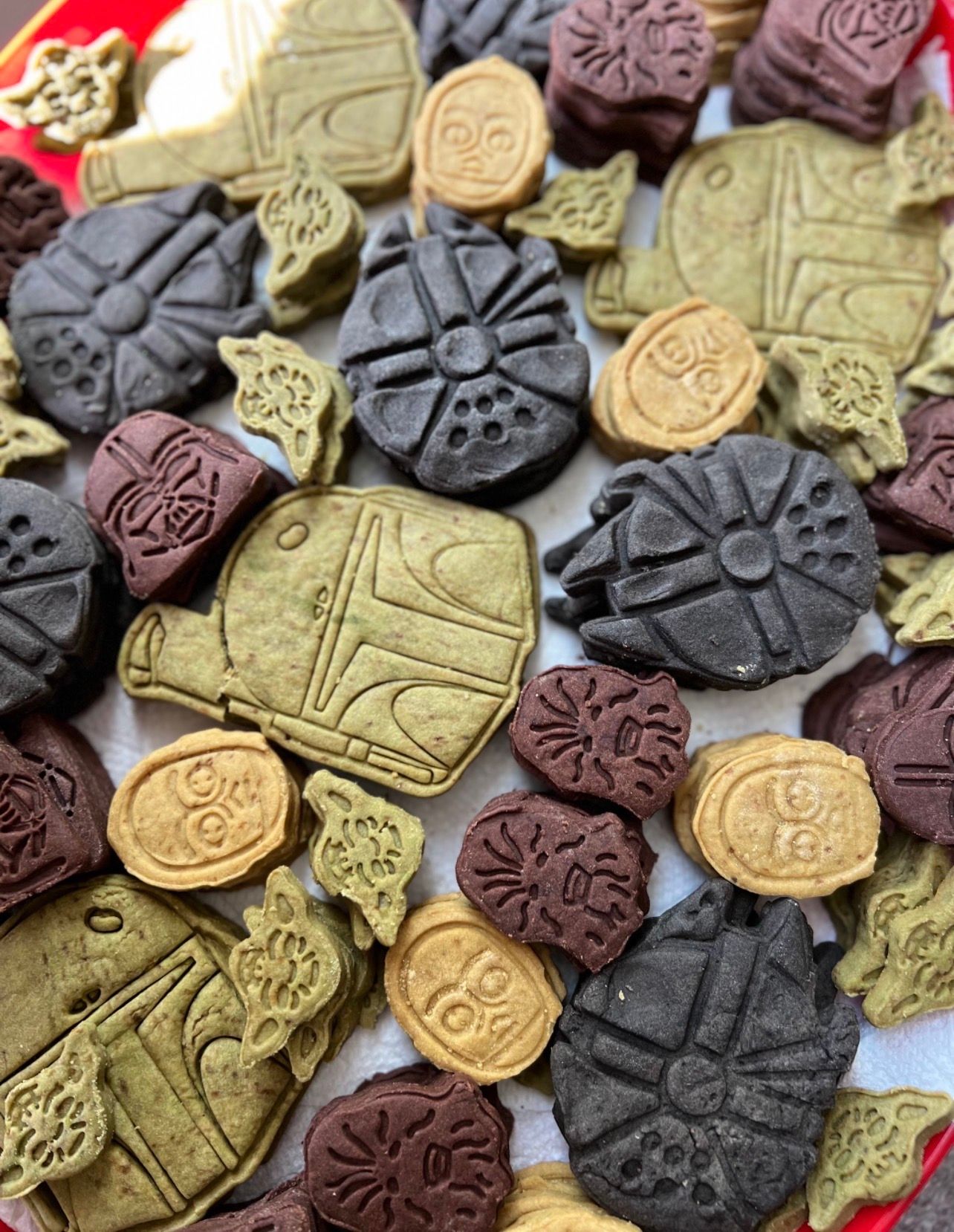 Pressed cookies in matcha, cocoa and vanilla, each embossed with a different design.